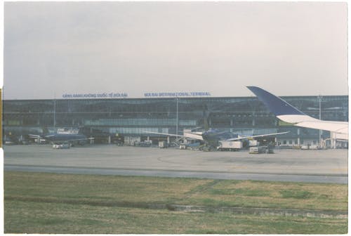 A photo of an airport with planes parked on the tarmac