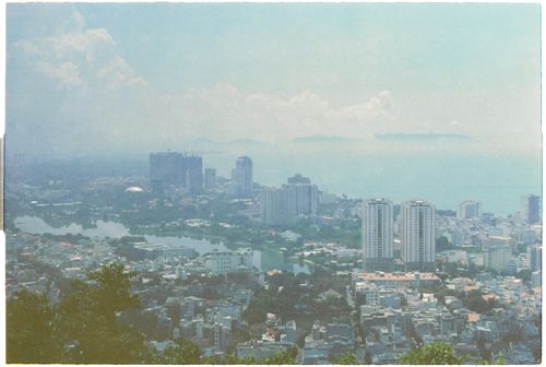 Free Aerial view of Vung Tau cityscape with tall buildings and coastline under a bright sky. Stock Photo
