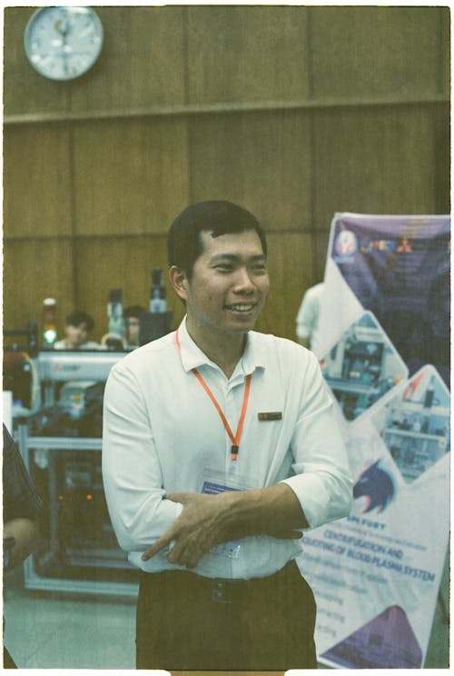 A man standing in front of a table with a computer