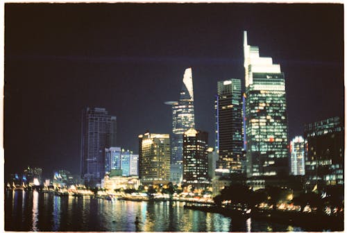 A city skyline at night with lights and water