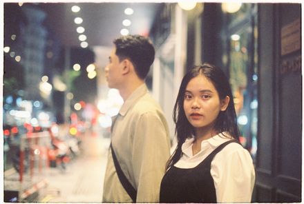 Two people on a city street at night — Toàn Văn on Pexels