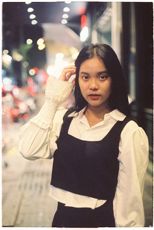 A young asian woman in a black and white shirt