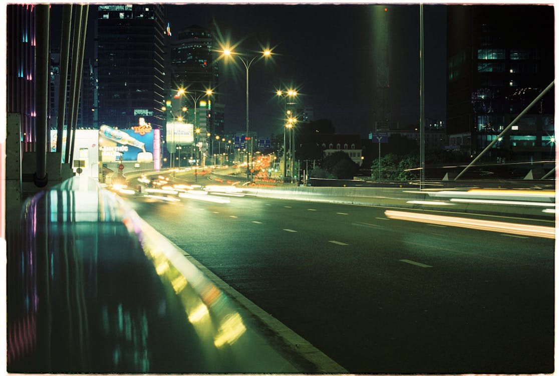 A long exposure photograph of a city street at night