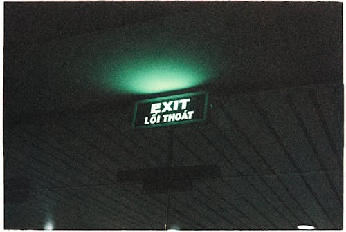 A green exit sign on a wall