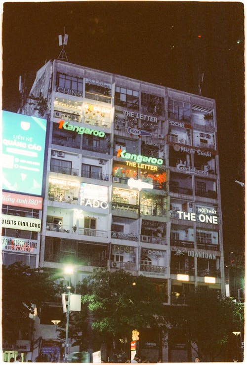 A photo of a building with neon lights on it