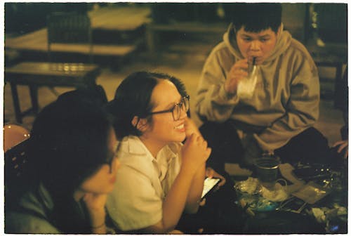 A group of people sitting around a table eating