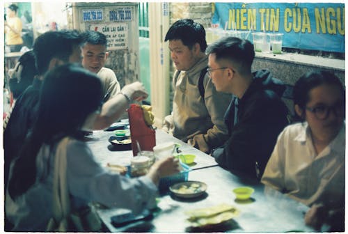 A group of people sitting at a table eating