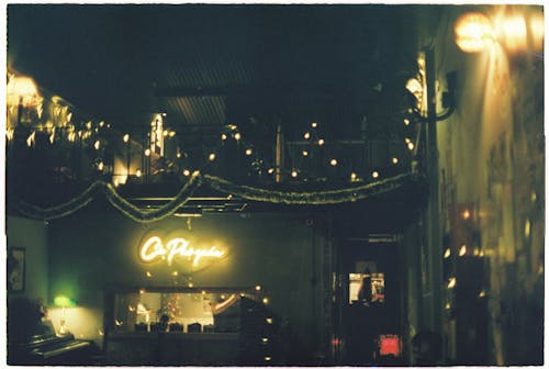 A restaurant with lights and a sign that says ope