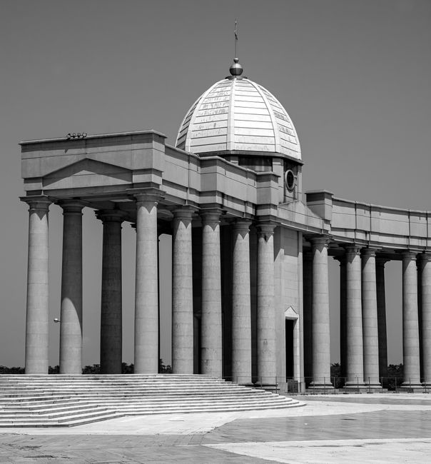 Majestic black and white image of a basilica showcasing grand pillars and a domed roof.