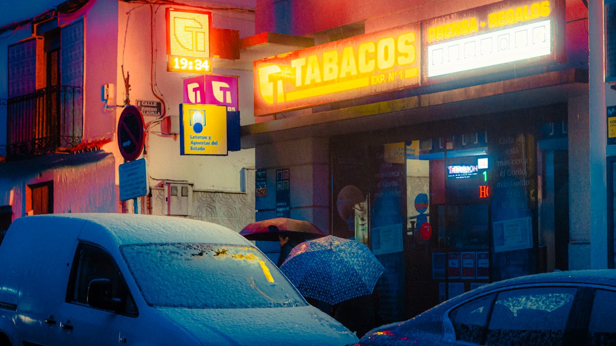 Snow on Cars near Store in Town