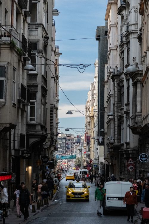 Free Vibrant street view in Istanbul showcasing pedestrians, taxis, and historic architecture. Stock Photo