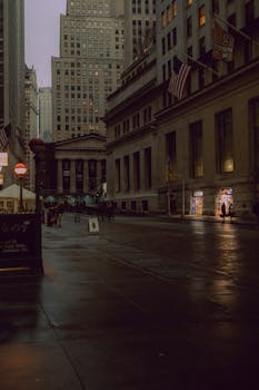Dimly lit evening street scene in New York City, showcasing architecture and urban life.