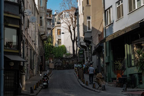 A narrow street with people walking down it