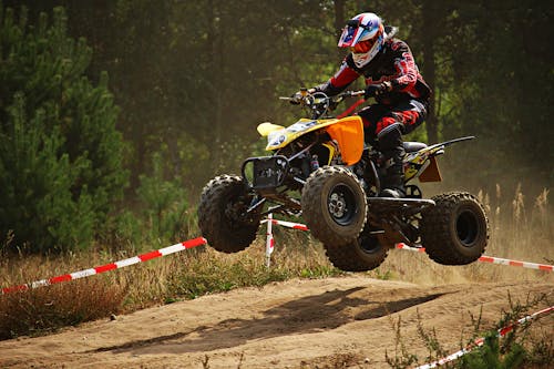 Free Person Riding Atv on Dirt Road Stock Photo