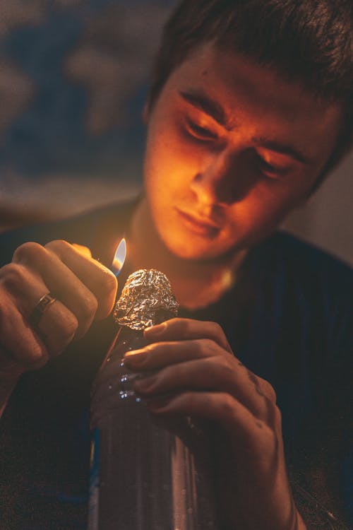 Man Holding Lighter over Foil