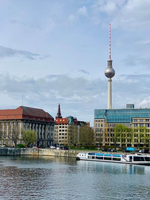 Free Scenic view of Berlin's skyline featuring the iconic Fernsehturm tower and a river. Stock Photo