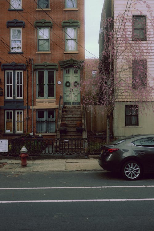 A car parked in front of a house on a street