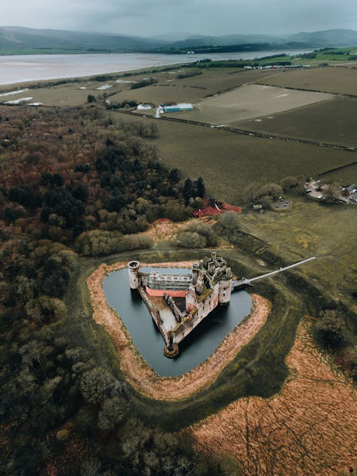 An aerial view of a castle in the middle of a lake
