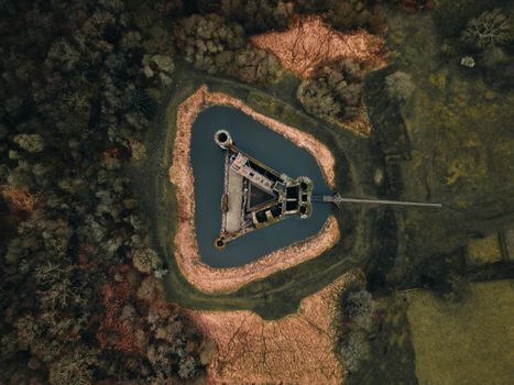 Drone capture of Caerlaverock Castle surrounded by a moat in Scotland. Aerial perspective.