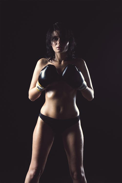 Free Woman in Black Panty Wearing Black Boxing Gloves Posing for Picture Stock Photo