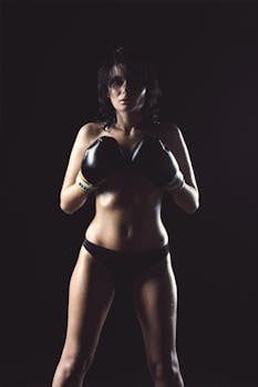 Woman in Black Panty Wearing Black Boxing Gloves Posing for Picture