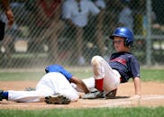 在阳光明媚的场地上，年轻的棒球运动员们正在进行激烈的比赛