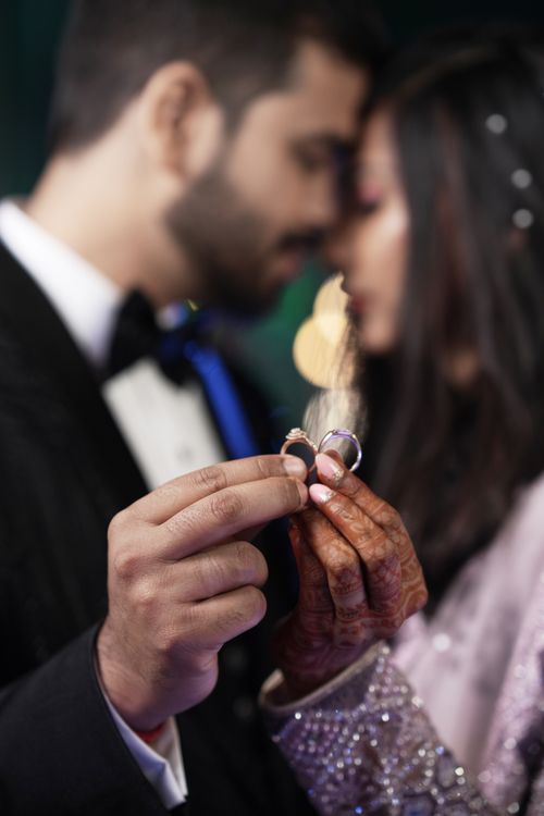 Free Close-up of a newlywed couple holding wedding rings, showcasing love and commitment. Stock Photo