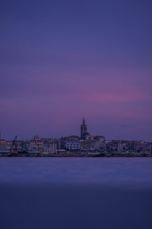 A purple sky with a city in the distance