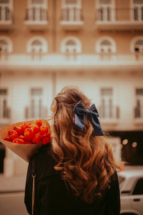 A woman with a bouquet of flowers in her hand
