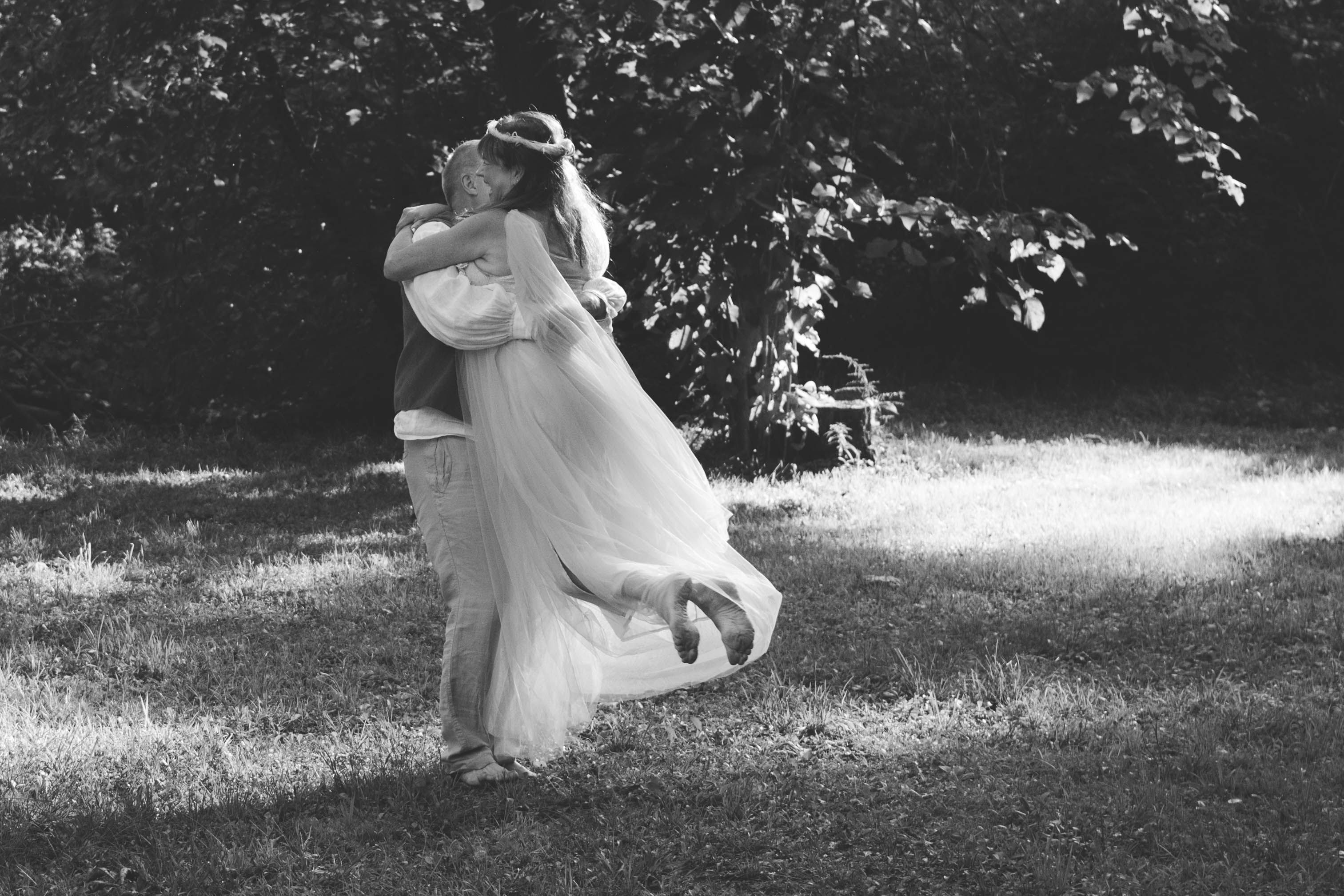 Newlyweds Hugging in Forest in Black and White · Free Stock Photo