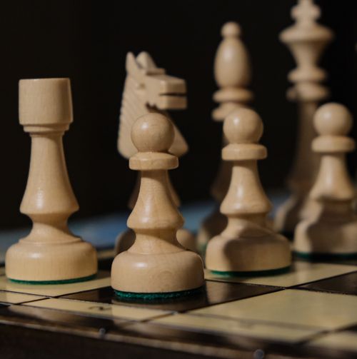 Free Detailed view of wooden chess pieces on a board with selective focus. Stock Photo