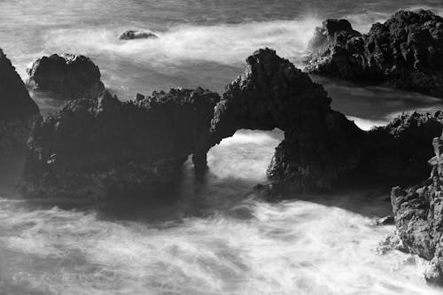 Black and white photograph of rocks in the ocean