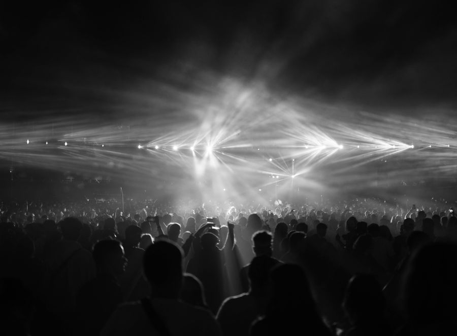 Black and white photograph of a crowd at a night show — photo by Ludvig Hedenborg on Pexels