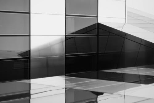 Black and white photo of a building with glass