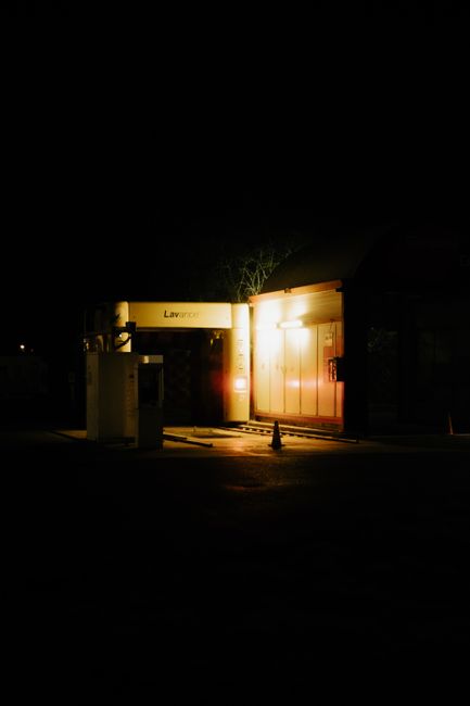 A closed car wash in Tournai illuminated by artificial light during nighttime.