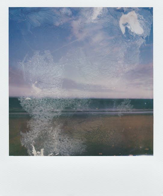 A vintage Polaroid image of a seaside landscape with a distressed, artistic effect, evoking nostalgia and tranquility.