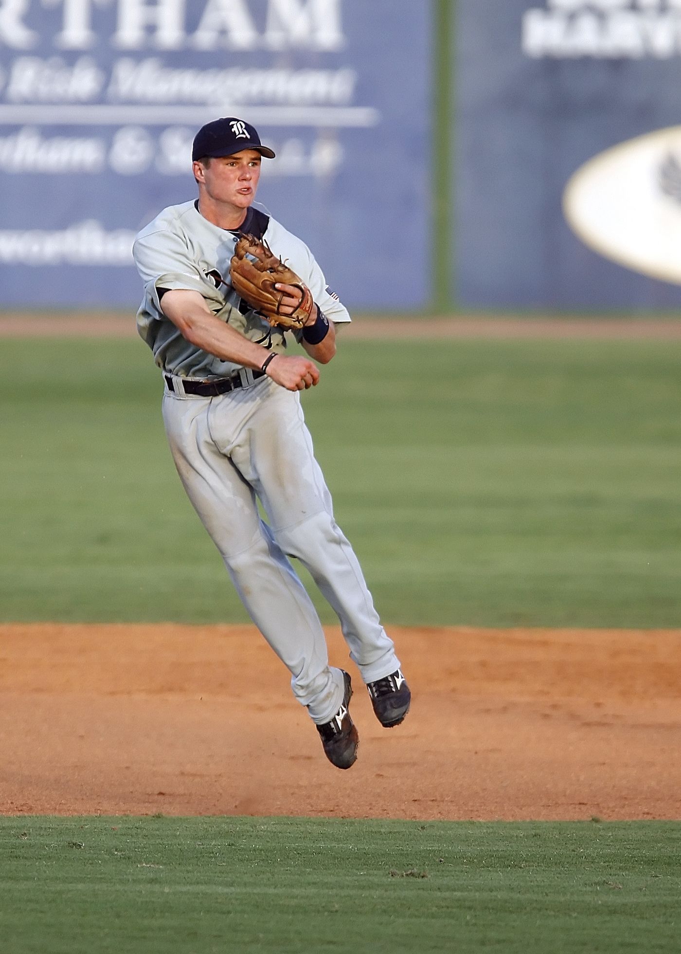 Infielder leaping to field a ball