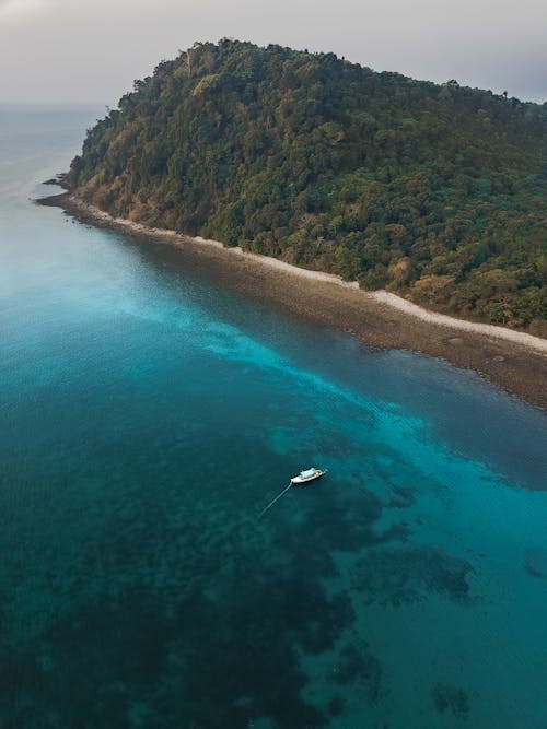 Free Aerial Photography Of Boat Sailing Near Island Stock Photo