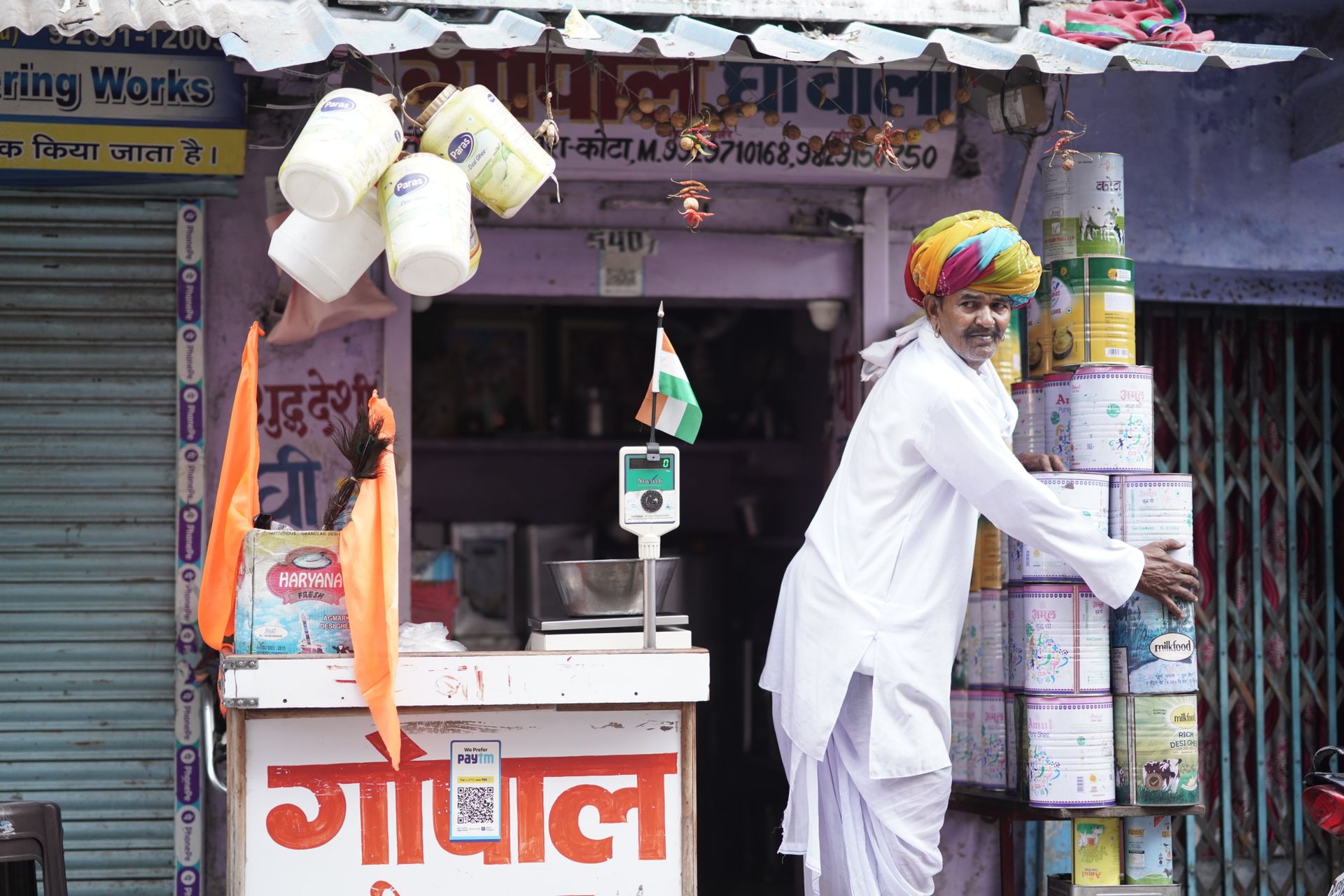A vibrant Indian merchant arranging products outside his shop in Kota, Rajasthan.
