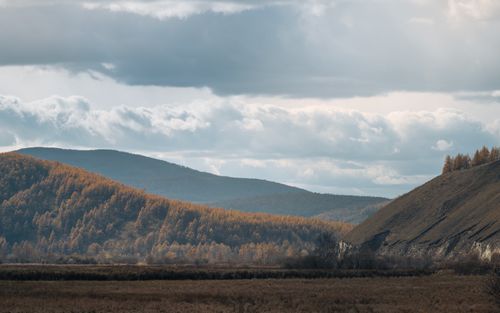 Free Beautiful autumn landscape with mountains and clouds under a blue sky. Stock Photo