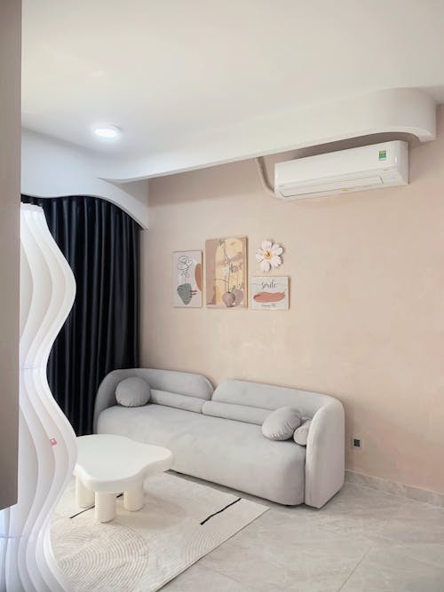 Free A living room with a white couch and air conditioning Stock Photo