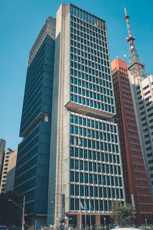 Free High-rise buildings in a bustling city center under a clear blue sky. Stock Photo