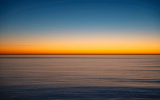 Tranquil sunset view over the ocean in Rancho Palos Verdes, California, with vibrant hues.