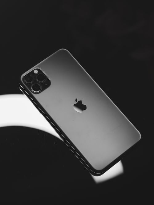 Free Elegant smartphone in a black and white studio setting, highlighting its sleek design. Stock Photo
