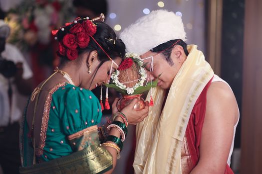 A beautiful traditional Indian wedding ritual in Nagpur featuring a bride and groom in vibrant attire.