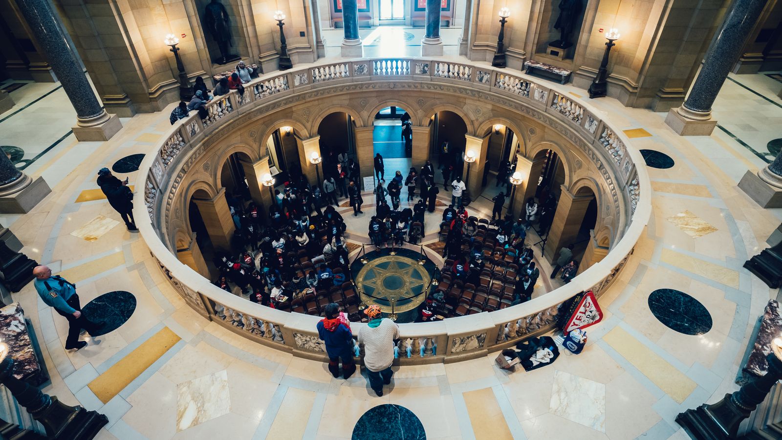 Interior view of a grand architectural rotunda with a gathering, highlighting luxurious design and modern elegance.