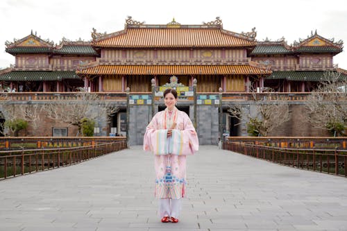 A woman in a kimono standing in front of a building