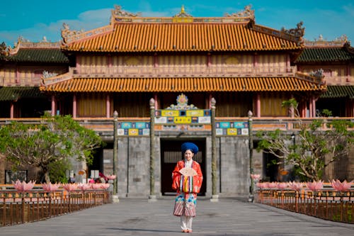 Woman in Traditional Clothing at Hue Imperial City in Hue in Vietnam