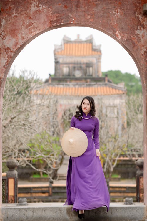 Woman in Purple Dress and with Conical Hat