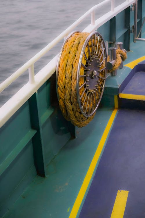 A yellow rope is tied to the side of a boat